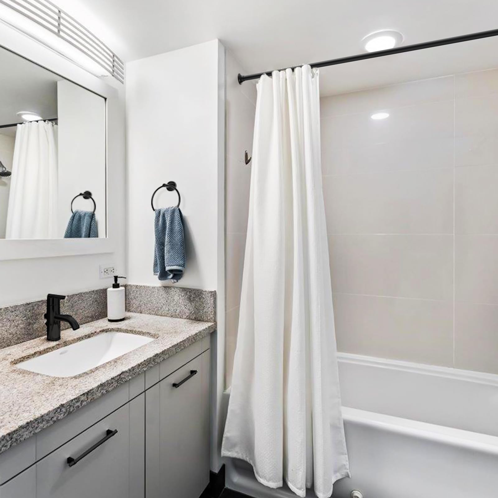 USHOWER Matuko Series – Matte Black Shower Curtain Rod Installed in Bathroom Over Bathtub with White Curtain Beside Vanity